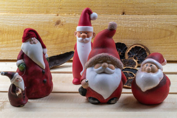 istock Red Santa Clauses on rustic wooden boards as Christmas decorations. 1292000161