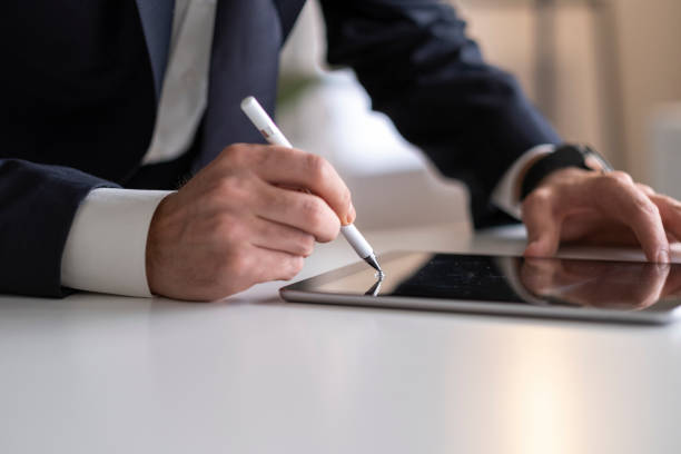 istock Businessman Signing Digital Contract On Tablet Using Stylus Pen 1292001123
