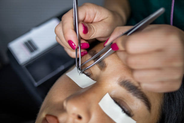istock Female eye with long lashes. Eyelash extension procedure. Eyelashes, close-up, macro, selective focus 1292001373