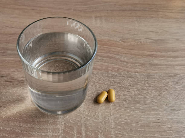 istock Glass of water and pills 1292001945
