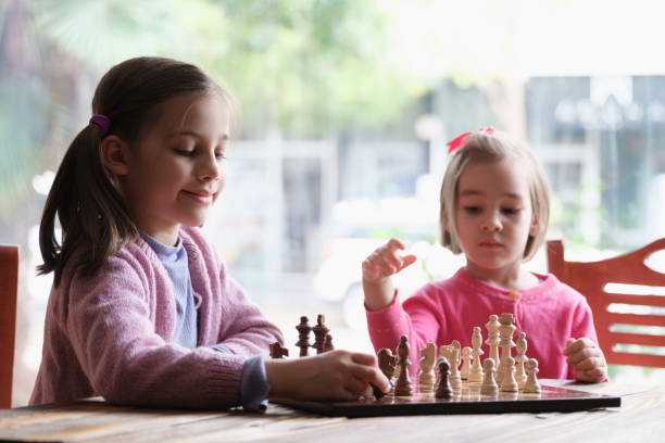istock Two Little Girls Playing Chess Together 1292002218