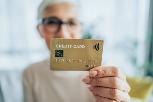 istock Woman holding a credit card. 1292002253