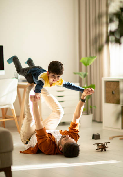 istock Joyful young man father lifting excited happy little son. 1292003036