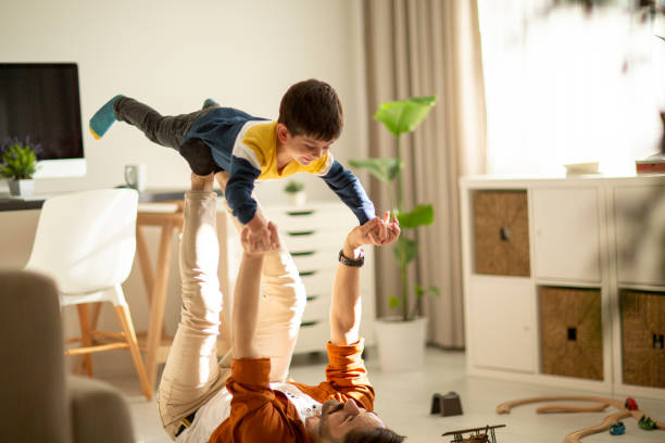 istock Joyful young man father lifting excited happy little son. 1292003038