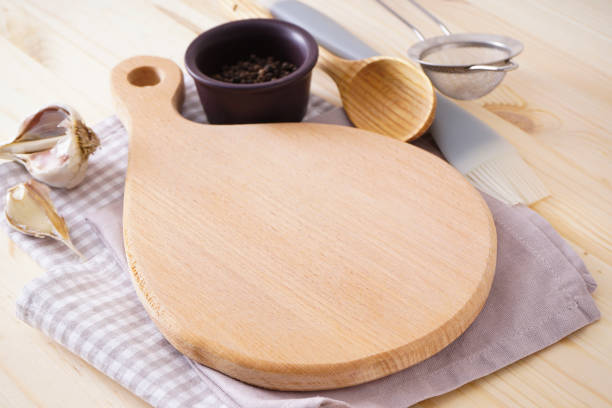 istock Wooden cutting board on wooden background, space for text. 1292003855
