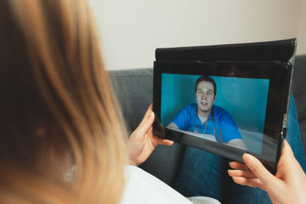 istock Woman making video call with her doctor. 1292004245