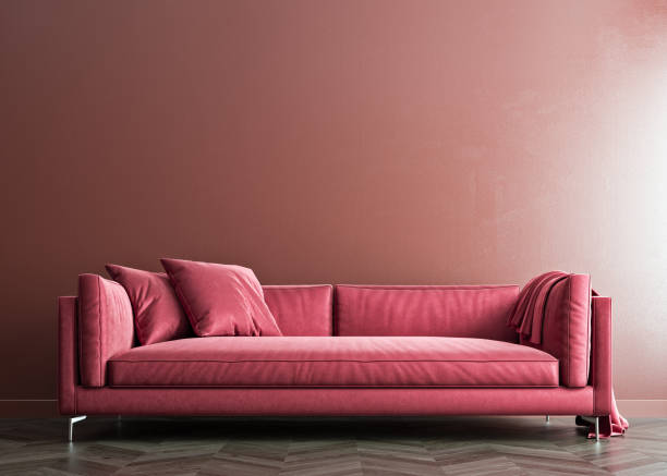 istock Indian red mock-up wall with hibiscus red sofa and pillows, modern interior, negative copy space above, 3d rendering 1292005164