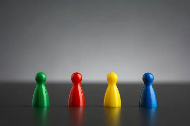 Photo of Group of four figurines in different colors in a row