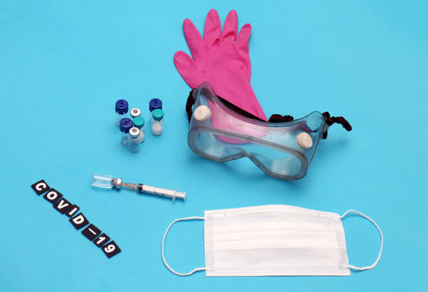 Covid-19 virus vaccine vials with syringe and medical equipment