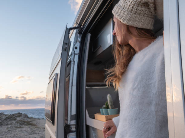 istock Woman looks at coastline from her van 1292006718