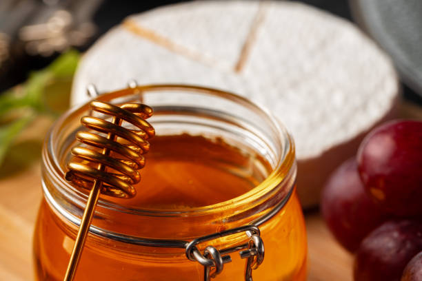 istock Cheese served with grapes and honey on grey surface 1292011425