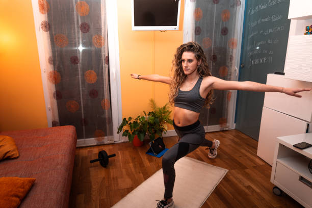 istock Young caucasian girl stretching before doing gym at home. 1292014319