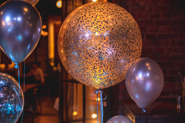 istock Decoration interior elements of restaurant venue banquet hall with multicoloured different helium balloons, on a indoor corporate event or wedding reception or birthday party celebration 1292018743