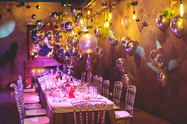 Decoration interior elements of restaurant venue banquet hall with multicoloured different helium balloons, on a indoor corporate event or wedding reception or birthday party celebration