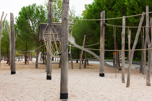 Empty playground of sand ground, wooden poles and ropes in Madrid, Spain. Covid 19 prevention, coronavirus lockdown concepts