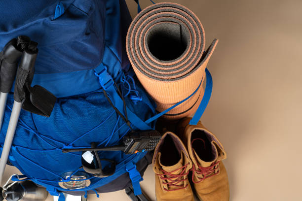 istock Blue backpack and hiking boots. Mountain gear close up 1292026053