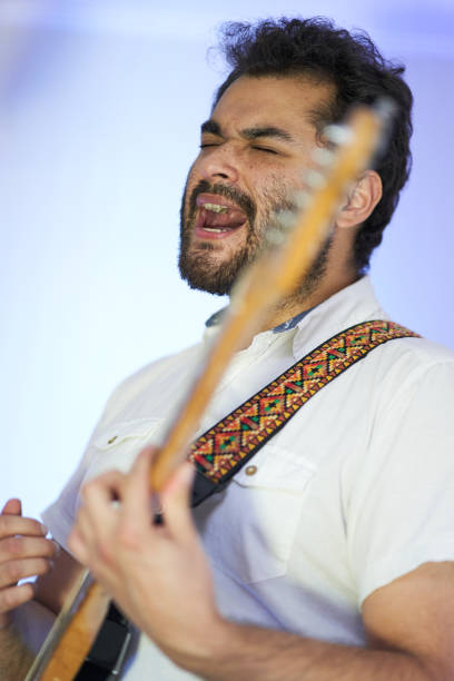 istock musician passionately singing and playing guitar 1292030774