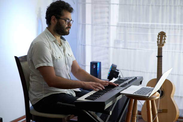 istock musician recording song from his home studio 1292030831