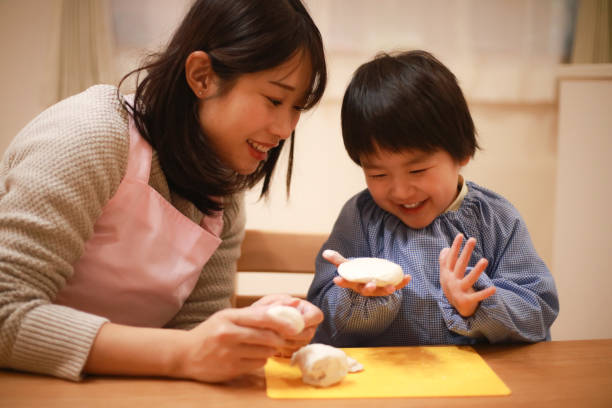 istock Image of boys and nursery teachers playing with clay 1292031632