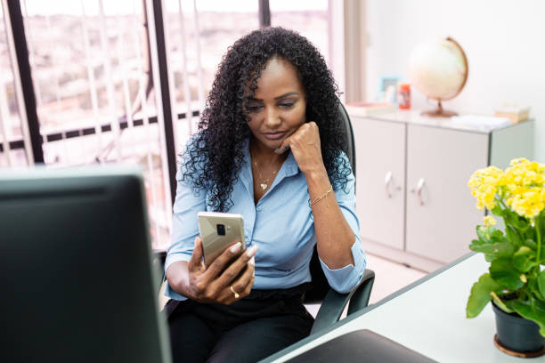 istock Woman checking messages on her cell phone. 1292032368