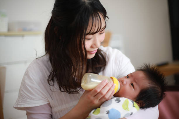istock Mother feeding her baby 1292035673