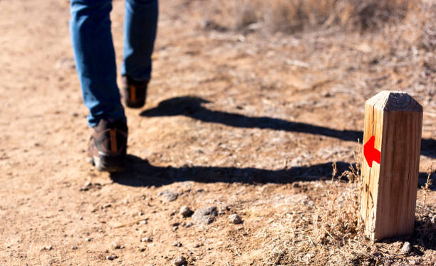 hiker passes trail marker with red arrow - camel back imagens e fotografias de stock