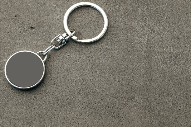 istock Metal key pendant on dark concrete background 1292037496