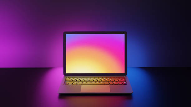 istock Laptop computer with blank purple screen placed on circle stand and blue lighting background. 1292038828