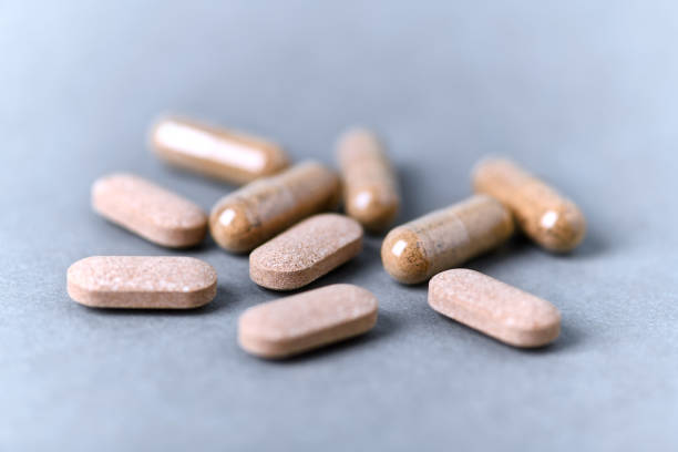 istock Ashwagandha (Withania somnifera) tablets and capsules on paper background. Close up. 1292047319