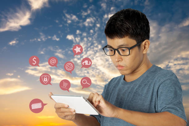 istock man using a tablet with notification icons network on social media interactions and digital transformation internet of things. 1292049058