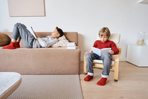 istock Kids sitting and reading books at home 1292053722