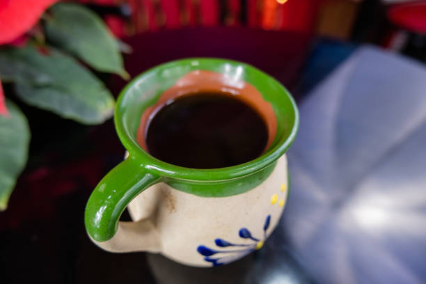 istock Mexican clay cup on a black table with blurry background 1292057862