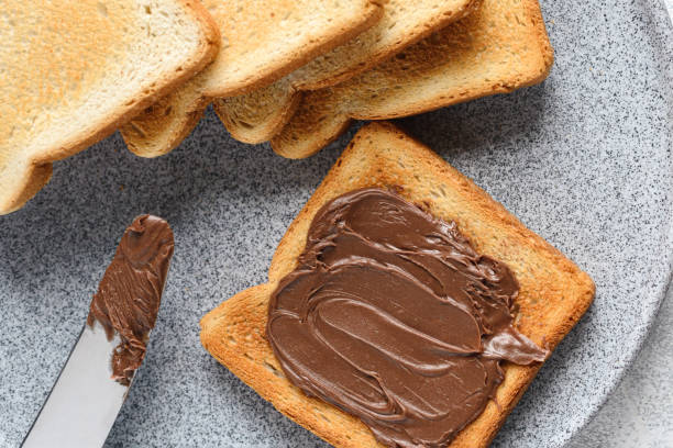istock Close-up toast with chocolate-nut paste spread in a plate 1292059544