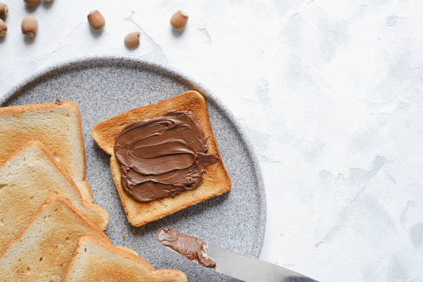 Toast with chocolate-nut paste spread in a plate with copy space