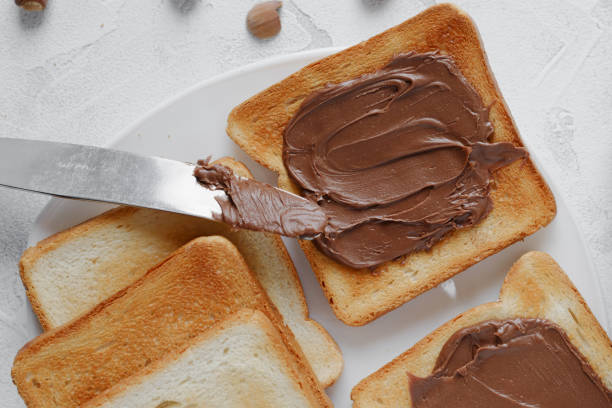 istock Close-up toast with chocolate-nut paste spread in a plate top view 1292059579