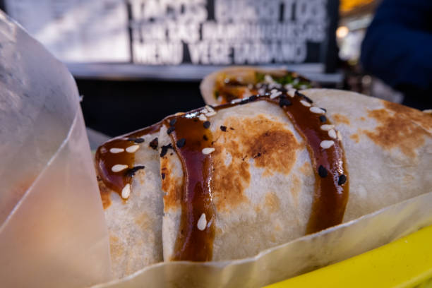 istock Burritos covered with sauce and seeds on a plastic basket 1292062659