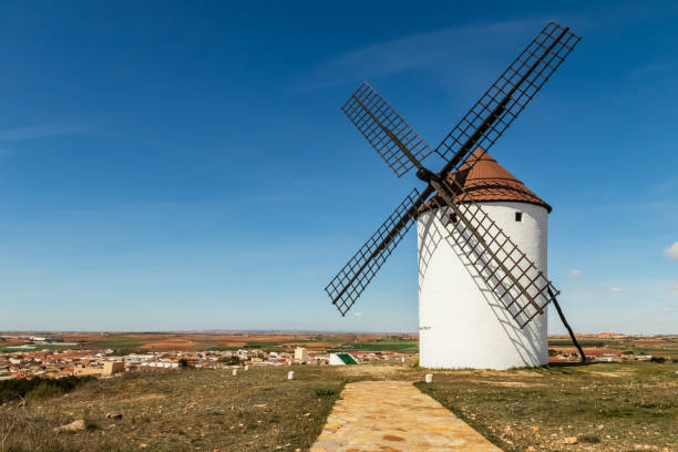 istock Ancient stone windmills in La Mancha. Blue sky with clouds. 1292063519