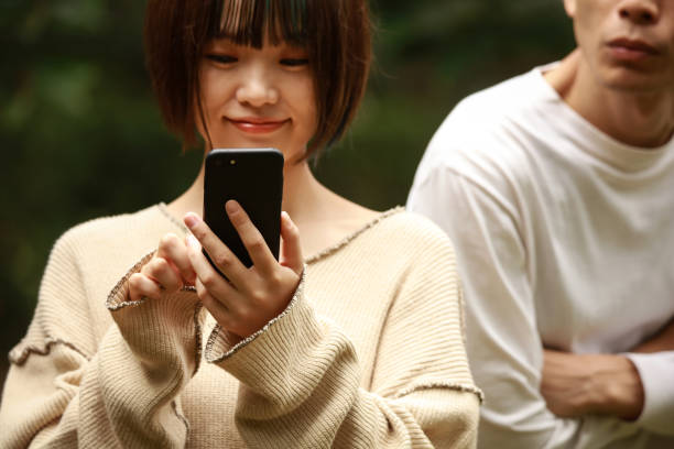 istock A man looking into a woman's smartphone 1292064404