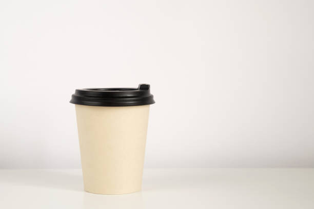 istock Coffee cup mockup on the white background. Empty cup on the table with copy space 1292064685