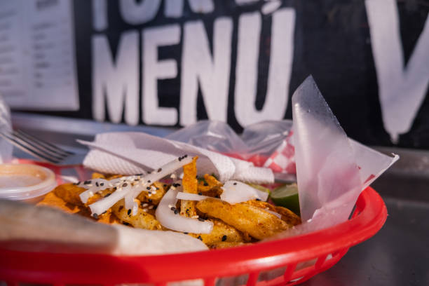 istock Fries and onions on a plastic basket with words behind it 1292065603