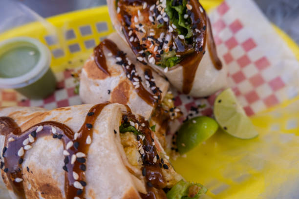 istock Burritos covered with sauce and seeds on a plastic basket 1292065692