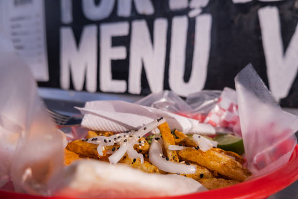 istock Fries and onions on a plastic basket with words behind it 1292065765