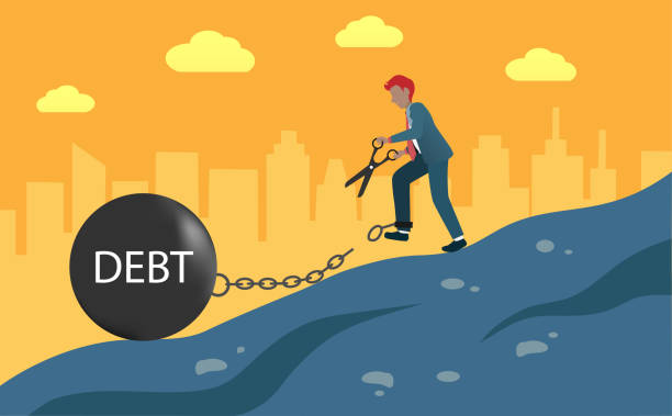 istock Businessman standing at hill with big scissor cut chains of dept on his leg. 1292066314