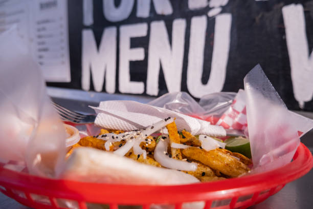 istock Fries and onions on a plastic basket with words behind it 1292066615
