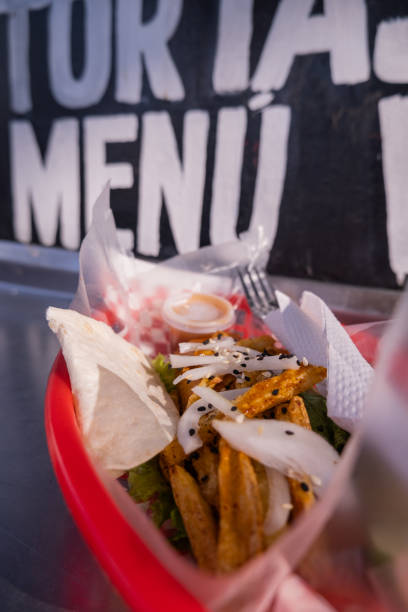 istock Fries and onions on a plastic basket with words behind it 1292066704