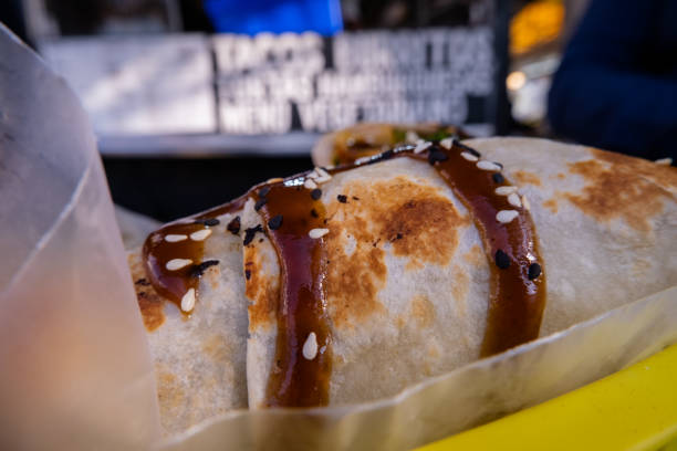 istock Burritos covered with sauce and seeds on a plastic basket 1292066765
