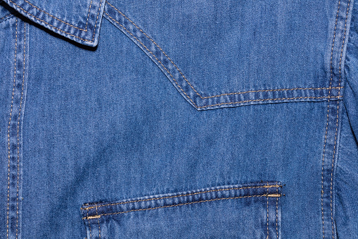 Close up shot of blue denim jeans shirt. Clothing store and shopping concepts