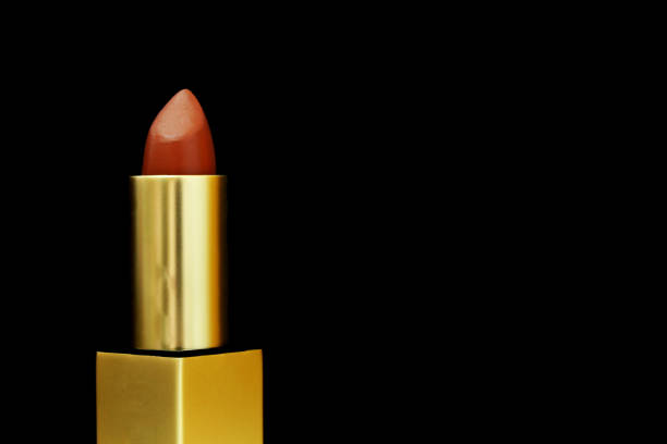 istock Close-up red brown lipstick isolated on dark backdrop. 1292068663