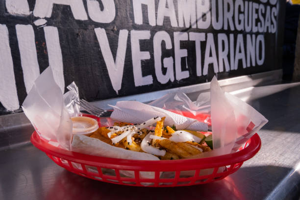 Fries and onions on a plastic basket with words behind it
