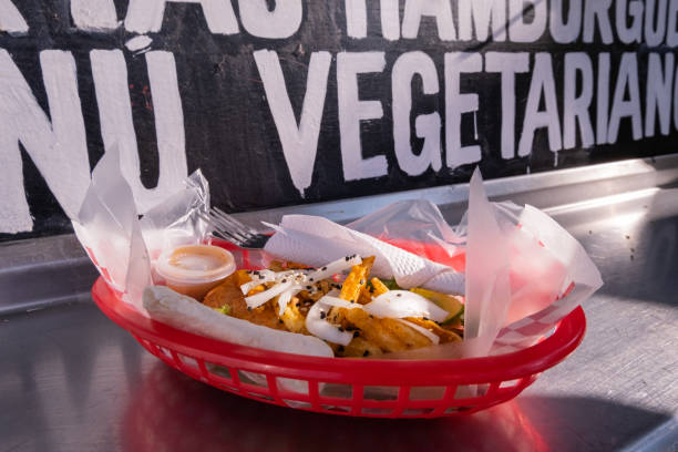 istock Fries and onions on a plastic basket with words behind it 1292068858